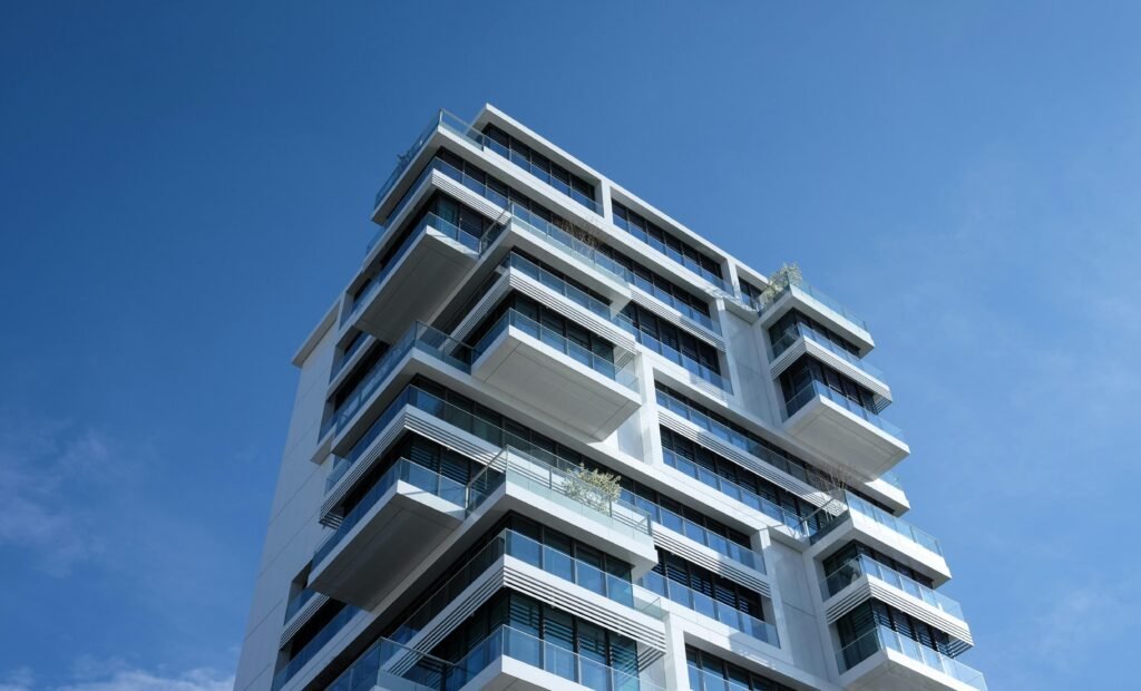 pexels-photo-87223-87223 Striking low-angle shot of a modern condominium with unique balcony design and clear blue sky.